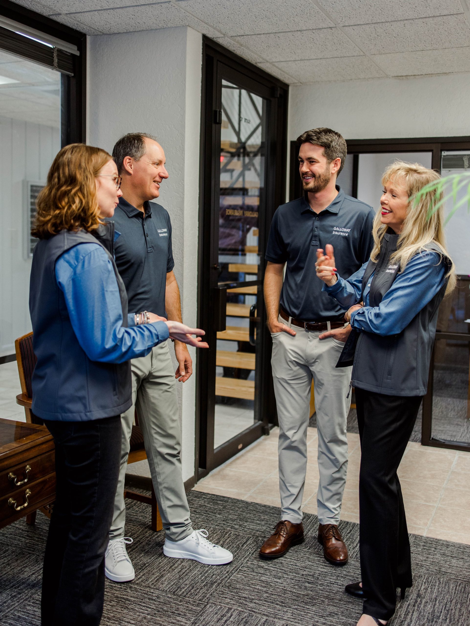 Galloway Insurance team Randal Dahl, Mike Stripling, Alisa Naumann, and Corine Ribera discussing personalized umbrella insurance coverage for Texas clients.